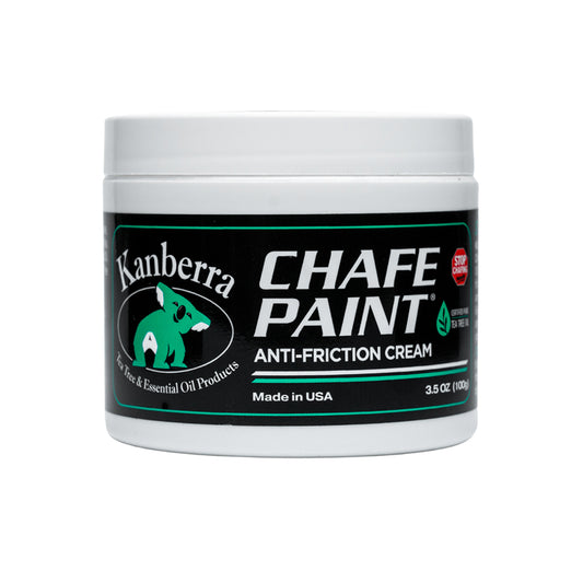 White jar of Kanberra Chafe Paint, featuring a koala and the label "Stop Odors." Anti-Friction Cream for Preventing Chafing, made with Certified Pure Tea Tree Oil