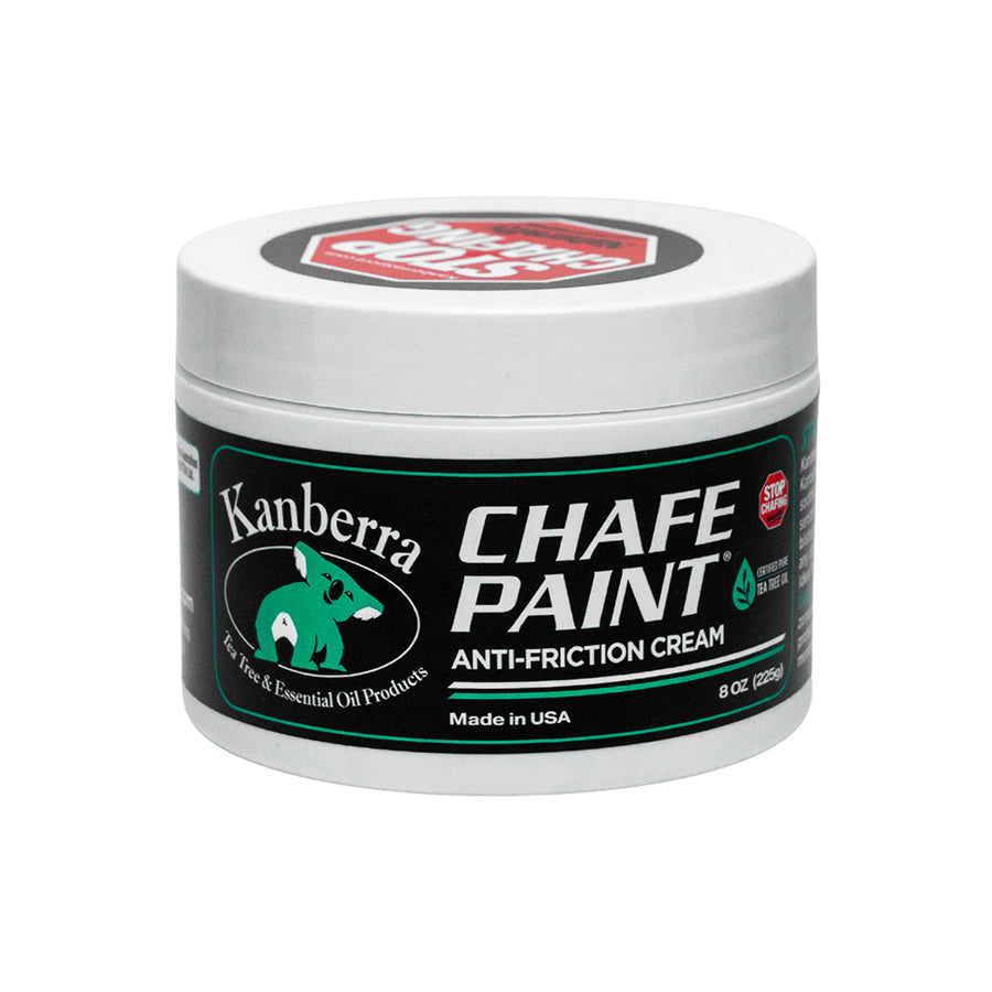 White jar of Kanberra Chafe Paint, featuring a koala and the label "Stop Odors." Anti-Friction Cream for Preventing Chafing, made with Certified Pure Tea Tree Oil