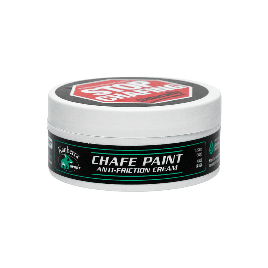 White jar of Kanberra Chafe Paint, featuring a koala and the label "Stop Odors." Anti-Friction Cream for Preventing Chafing, made with Certified Pure Tea Tree Oil